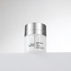 Trish McEvoy skincare jar on a light gray background