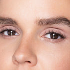 Close-up of a person's eyes with color rose quartz makeup
