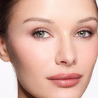 Close-up of a woman's face with a neutral background