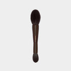 Makeup brush with brown handle and bristles on a light gray background
