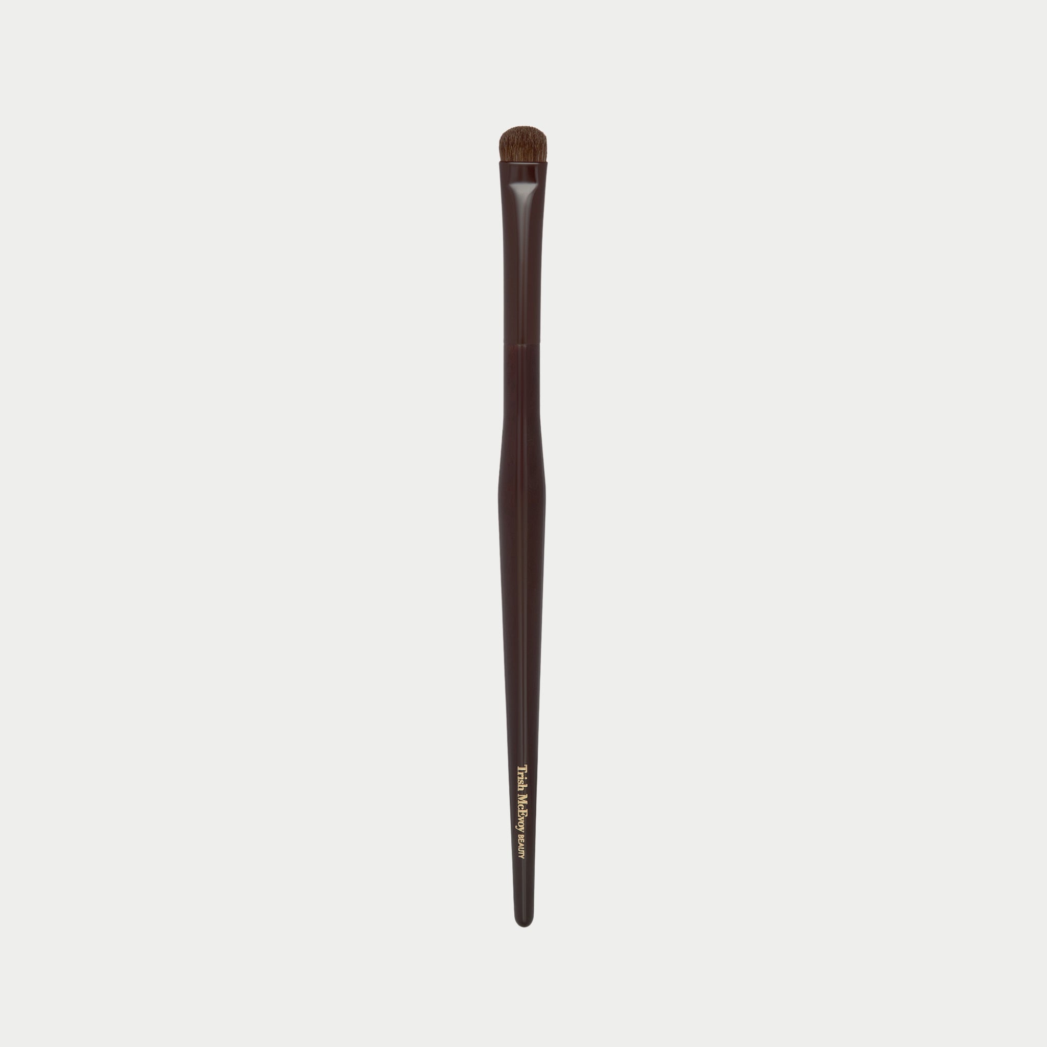 Makeup brush 54 with brown handle and black bristles on a white background