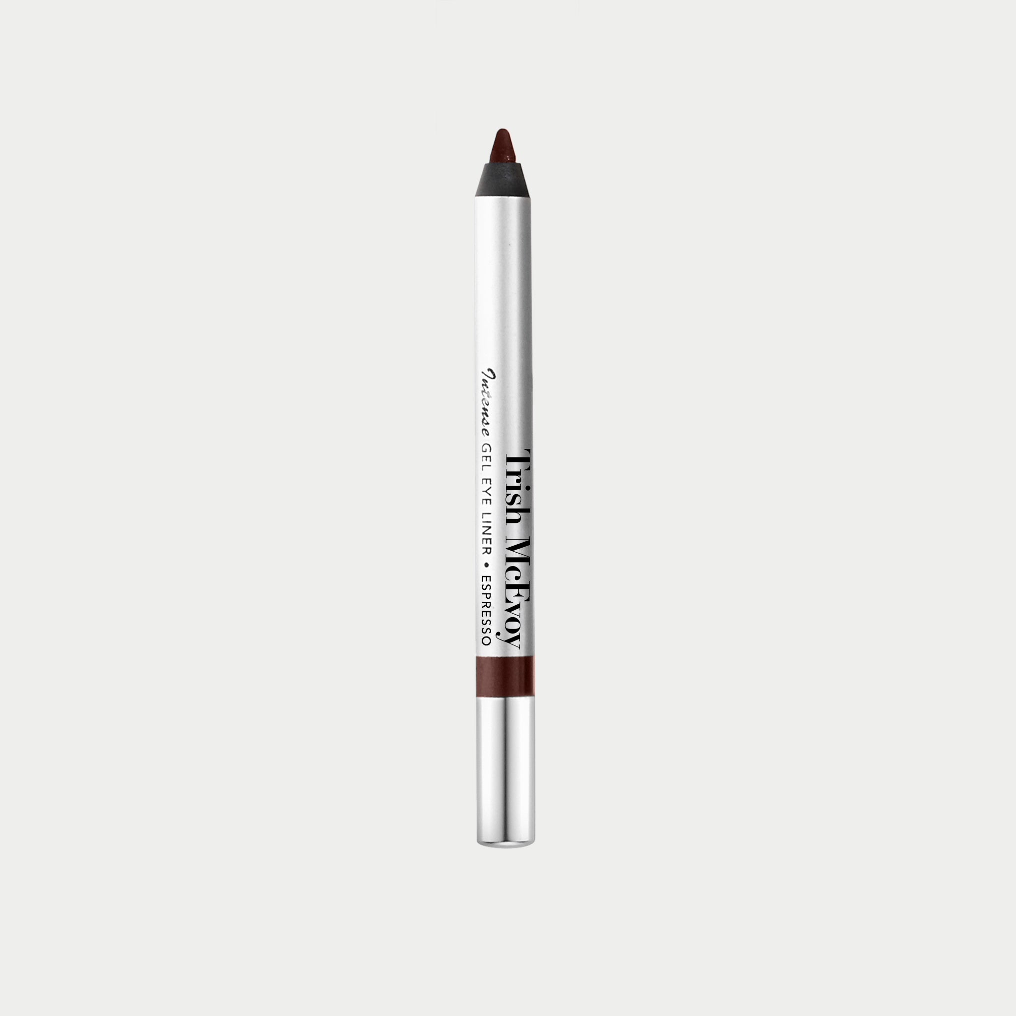 A single cosmetic eye liner pencil centered on a light gray background. The pencil has a silver body with black text reading 'Tush Metal' and 'Smoky Eye Liner • Eyeshadow', a dark brown exposed tip, and a brown band near the bottom.