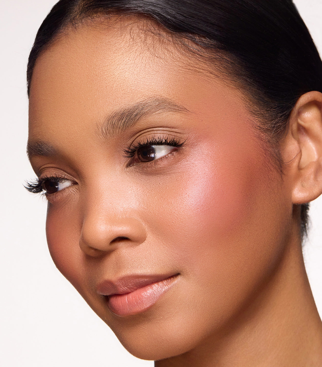 Close-up of a woman's face with a neutral background
