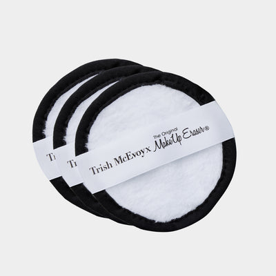 Three Trish McEvoy Make Up Eraser circular pads on a light gray background