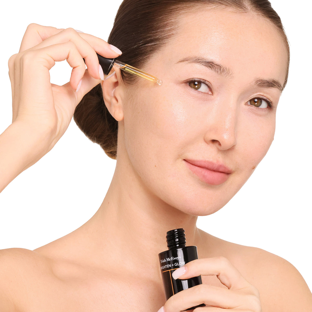 woman applying skincare product to her face