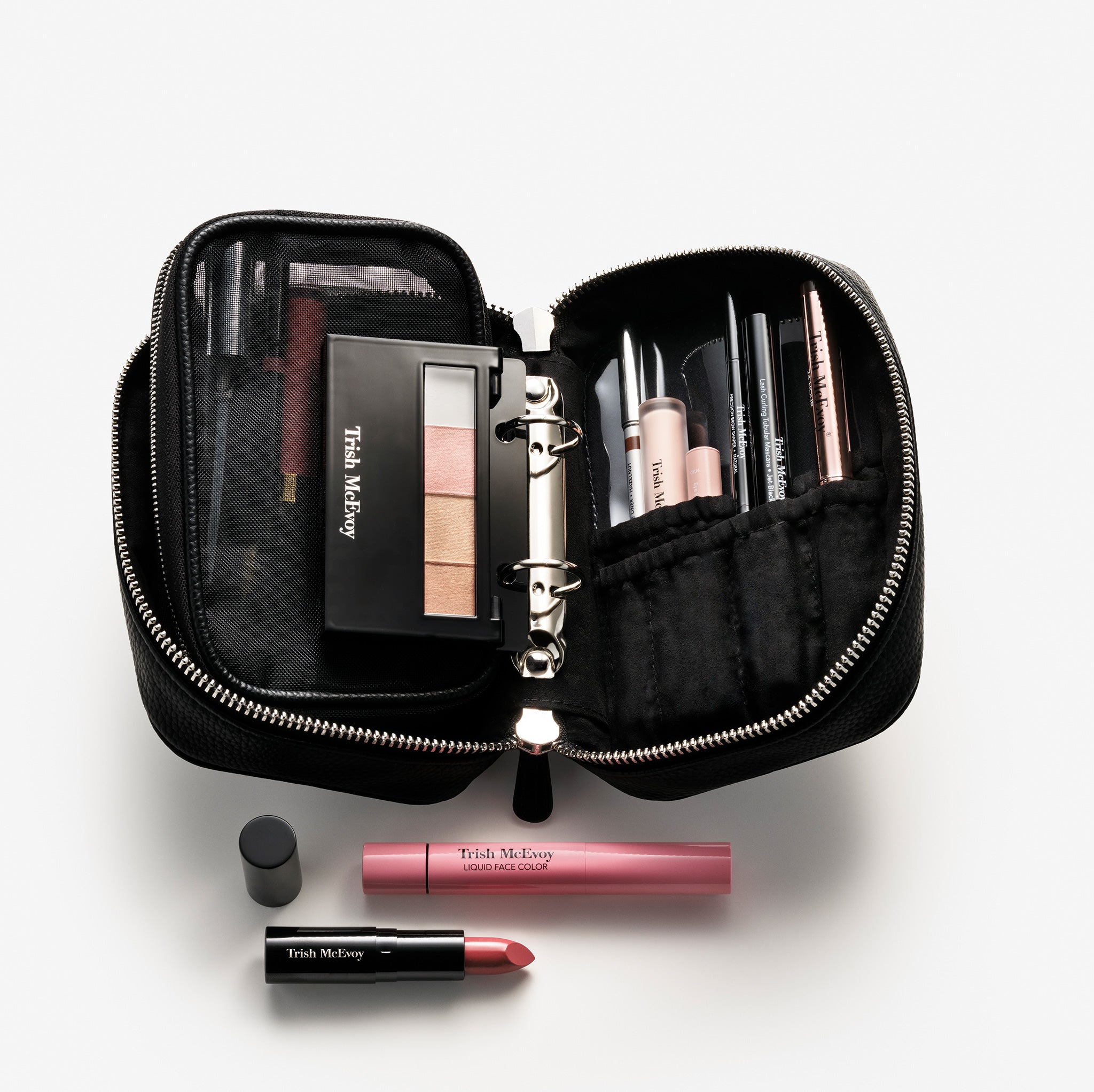 Makeup set with Trish McEvoy products on a light gray background