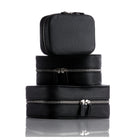 Set of three black leather planners  with silver zippers on a white background