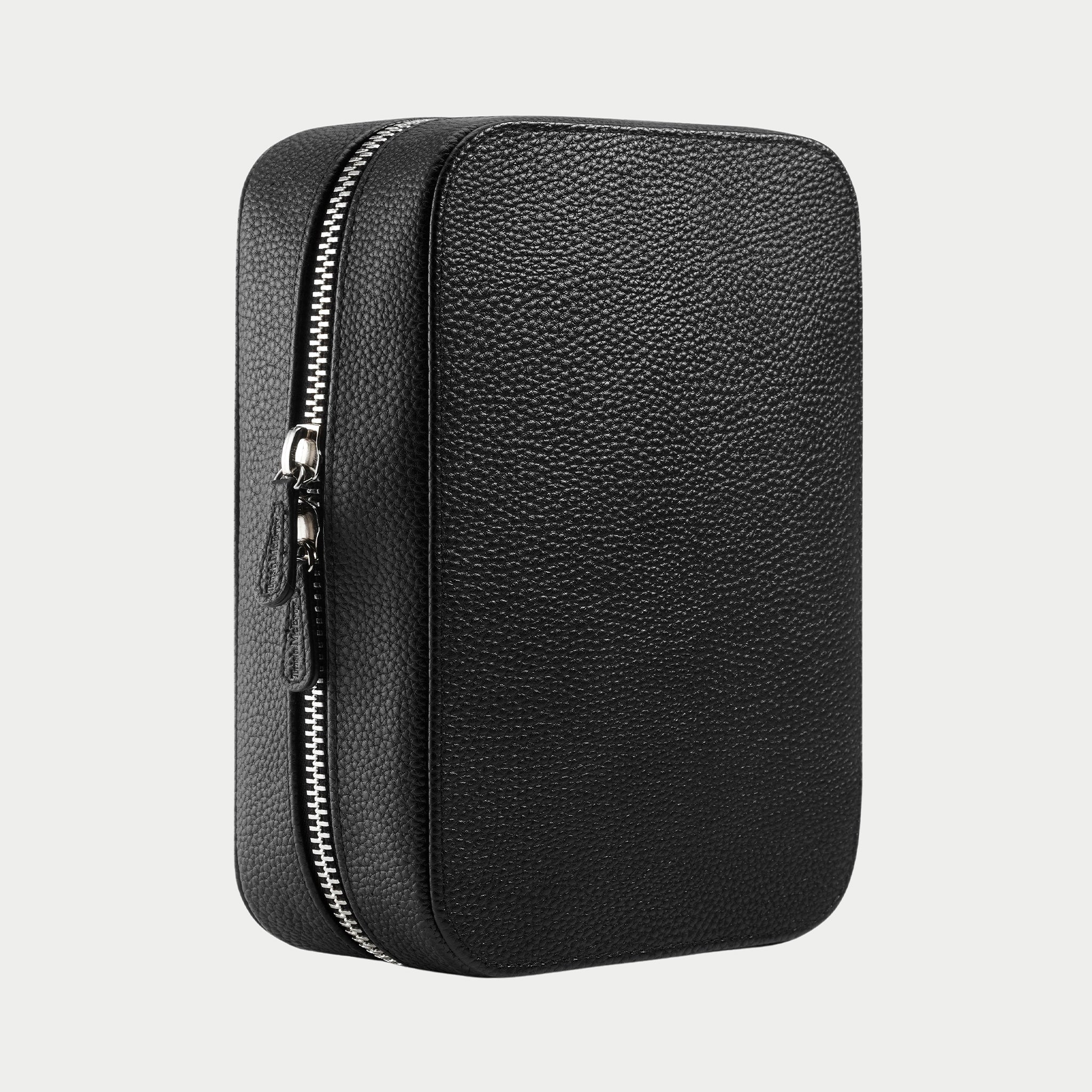 Black leather travel case with zipper on a light gray background