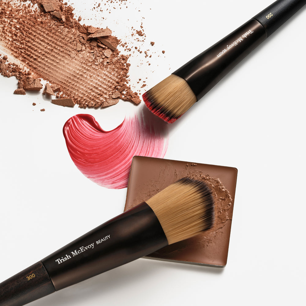 Makeup 200 brushes and brown powder on a white background
