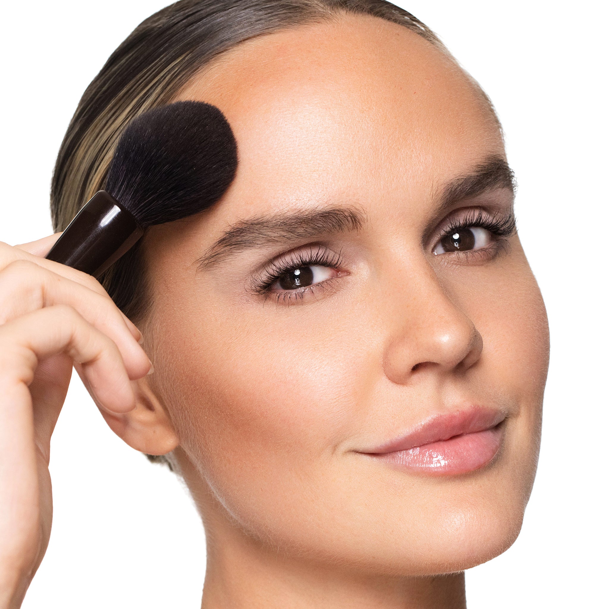 Woman applying dual resort with a brush on a white background