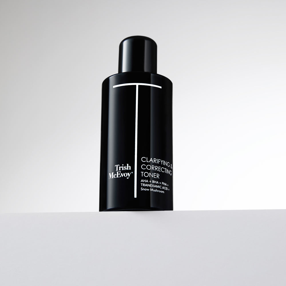 Black bottle of Trish McEvoy Clarifying & Correcting Toner on a light gray background