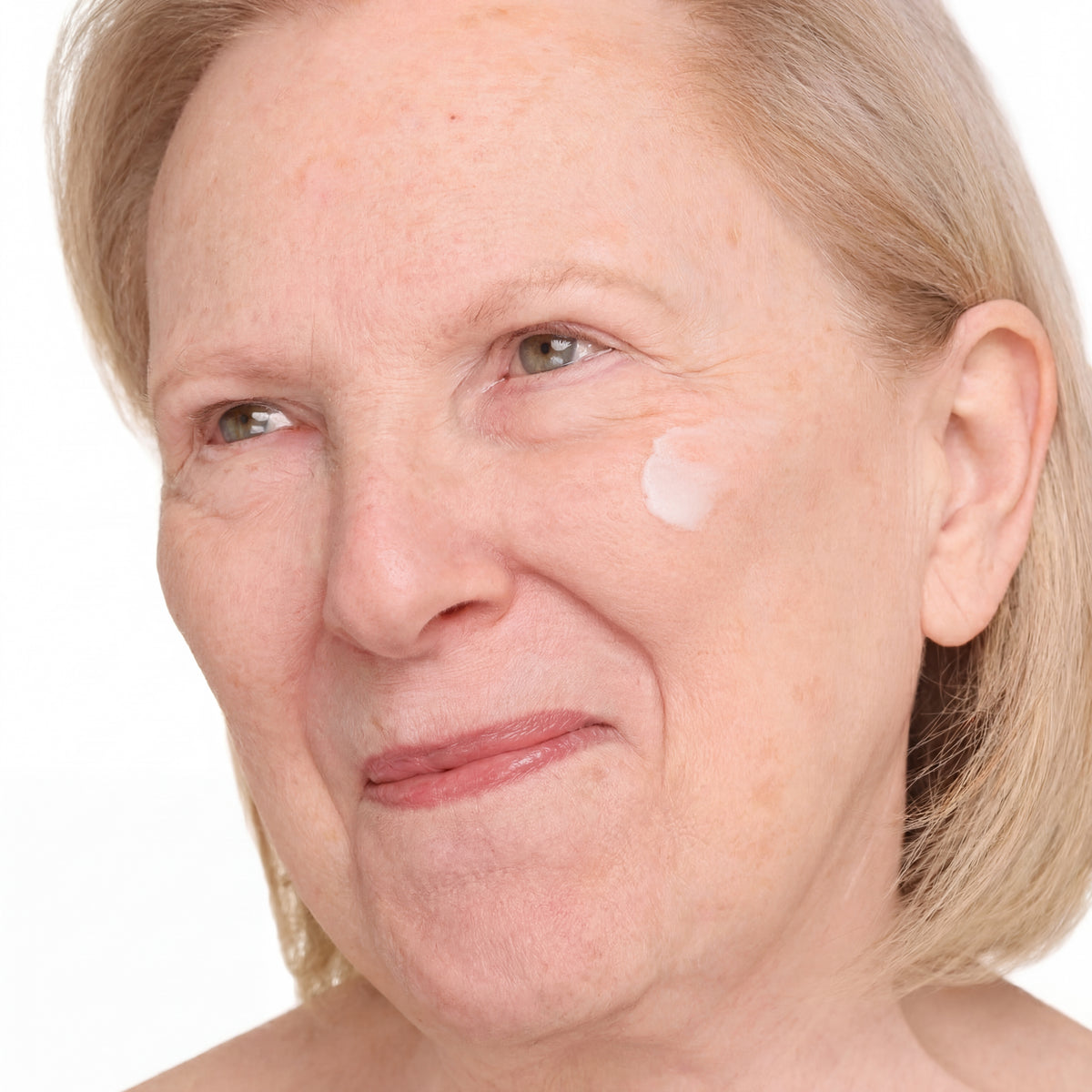 woman with skincare product on her face