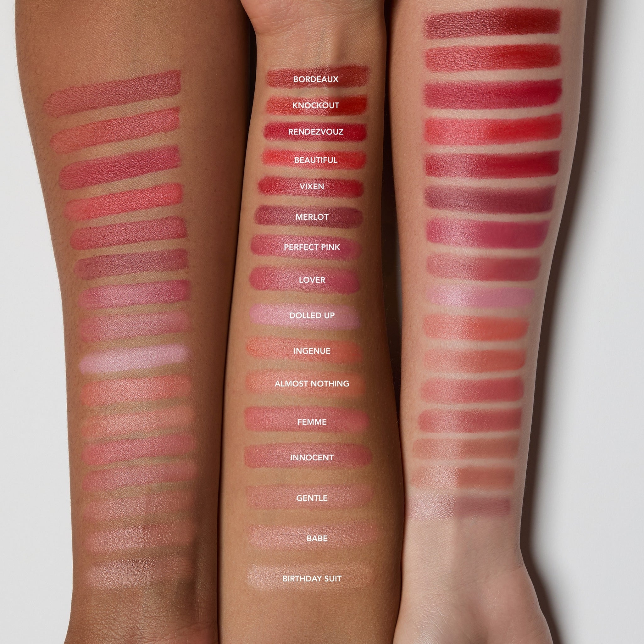 Lipstick swatches on a person's arm with names of colors underneath.