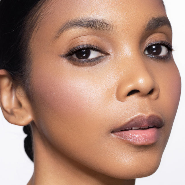 Close-up of a woman's face with color easy going blush