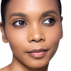 Close-up of a woman's face with pink glow blush