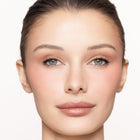 Close-up of a woman's face with color happy blush