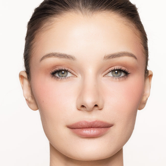 Close-up of a woman's face with color happy blush