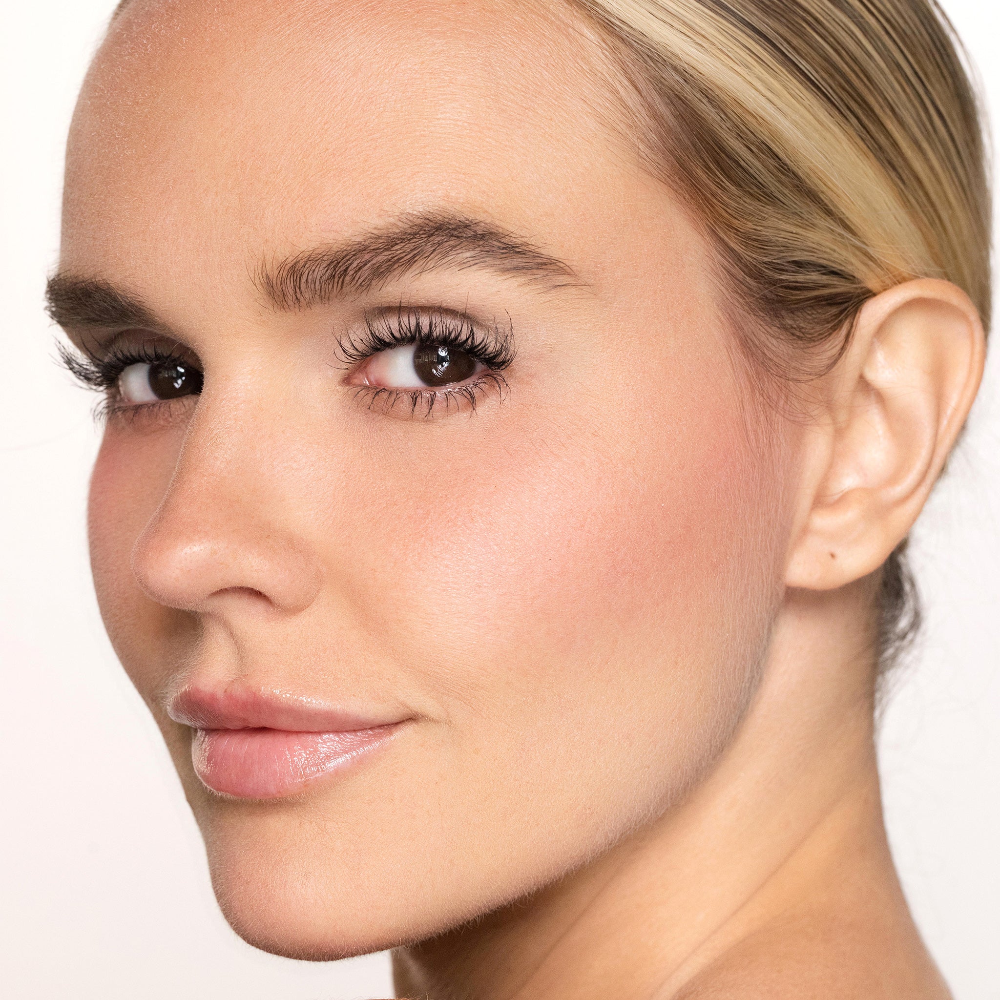 Close-up of a woman's face with color happy blush