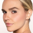 Close-up of a woman's face with color happy blush