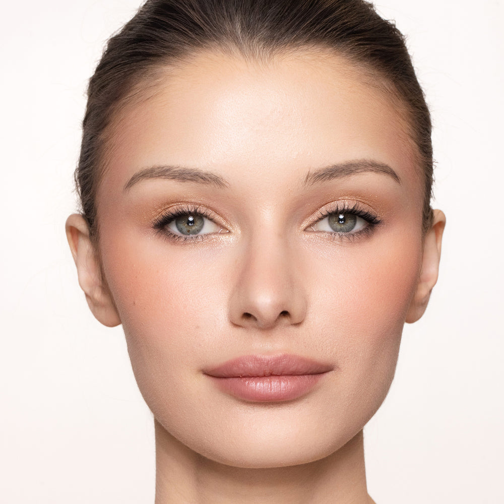 Close-up of a woman's face with color joyful blush