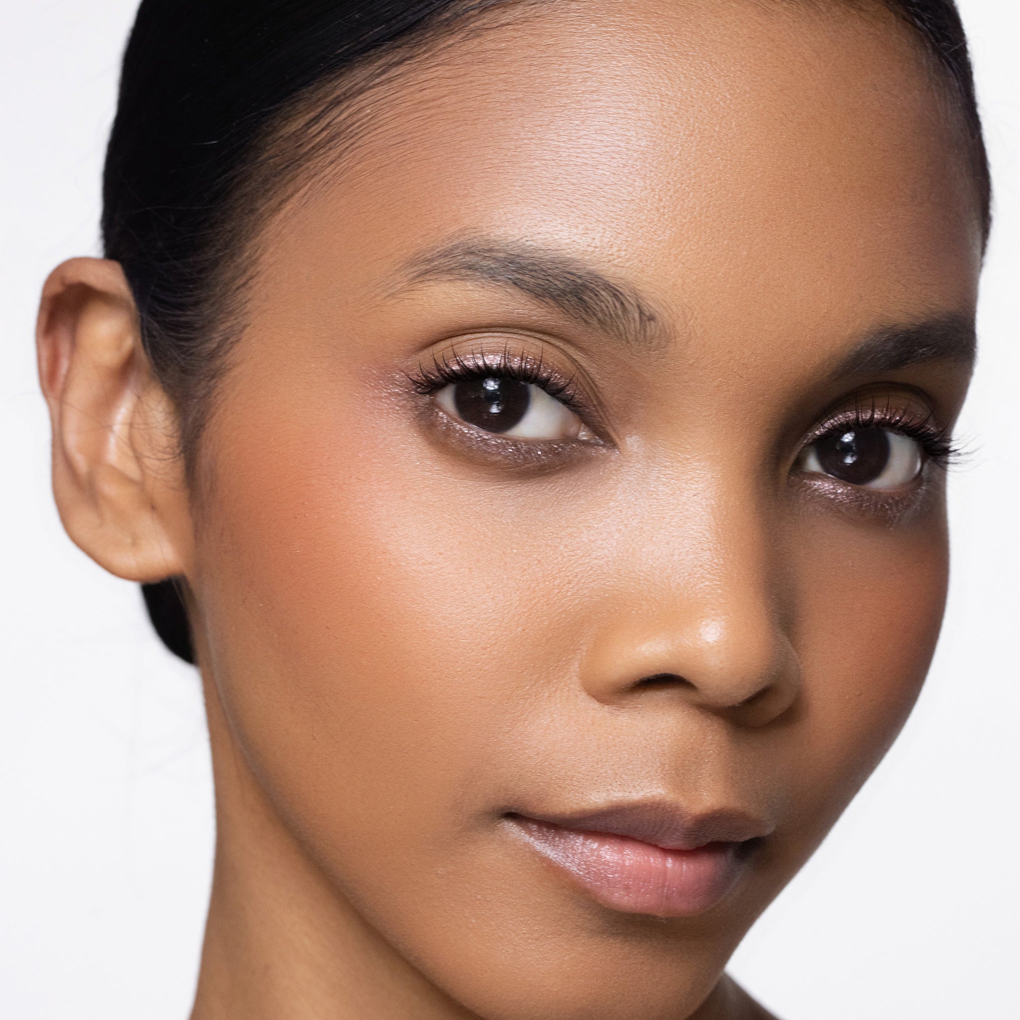Close-up of a woman's face with color joyful blush