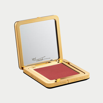Compact so sultry blush with gold case and mirror on a white background