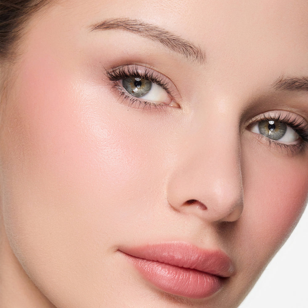 Close-up of a woman's face with color so pretty blush