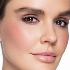 Close-up of a woman's face with so sultry cream blush