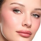 Close-up of a woman's face with so sultry cream blush