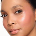 Close-up of a woman's face with a soft focus on her eye and cheek area.