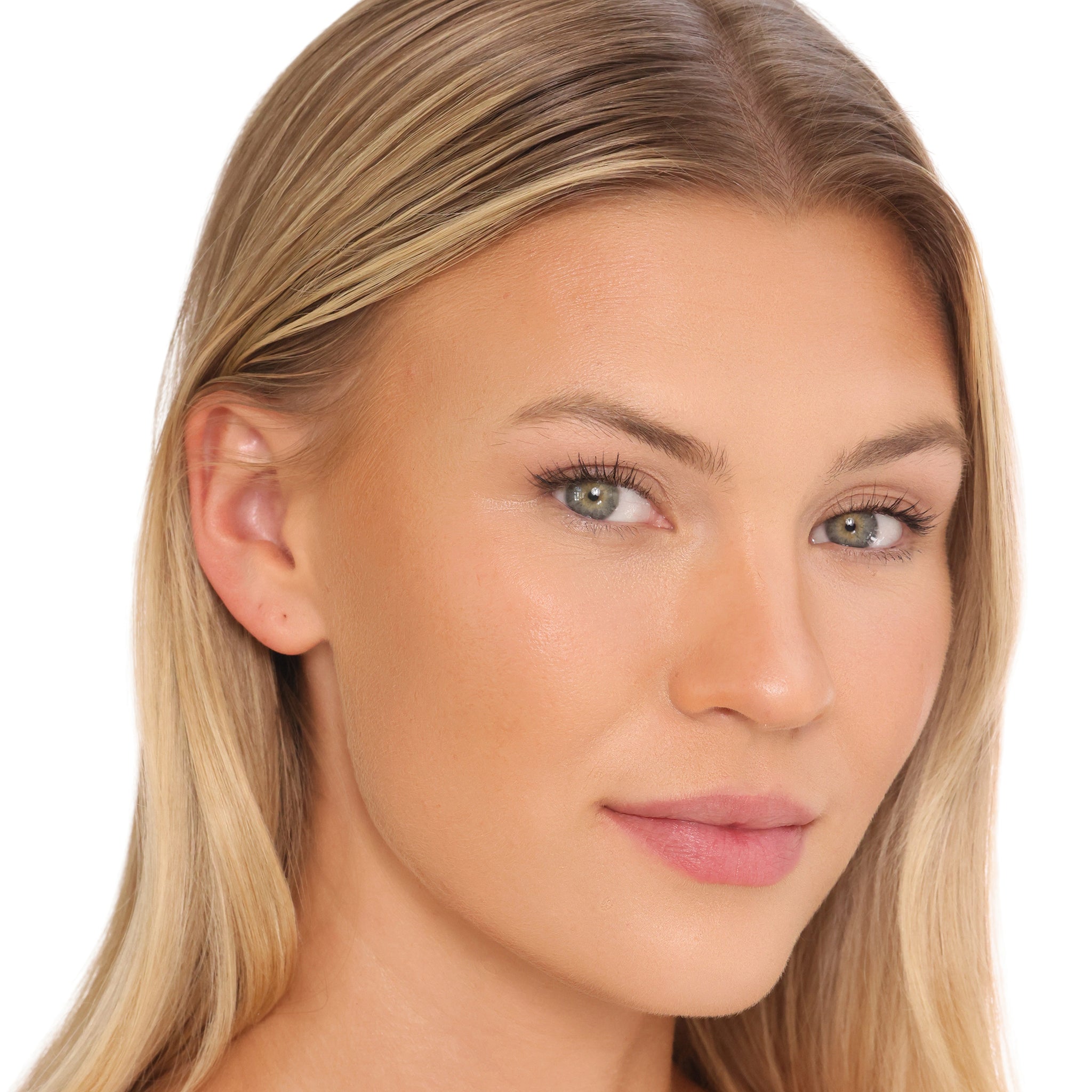 Close-up portrait of a woman with blonde hair and light green eyes, wearing a soft pink lip color, shown against a plain white background.