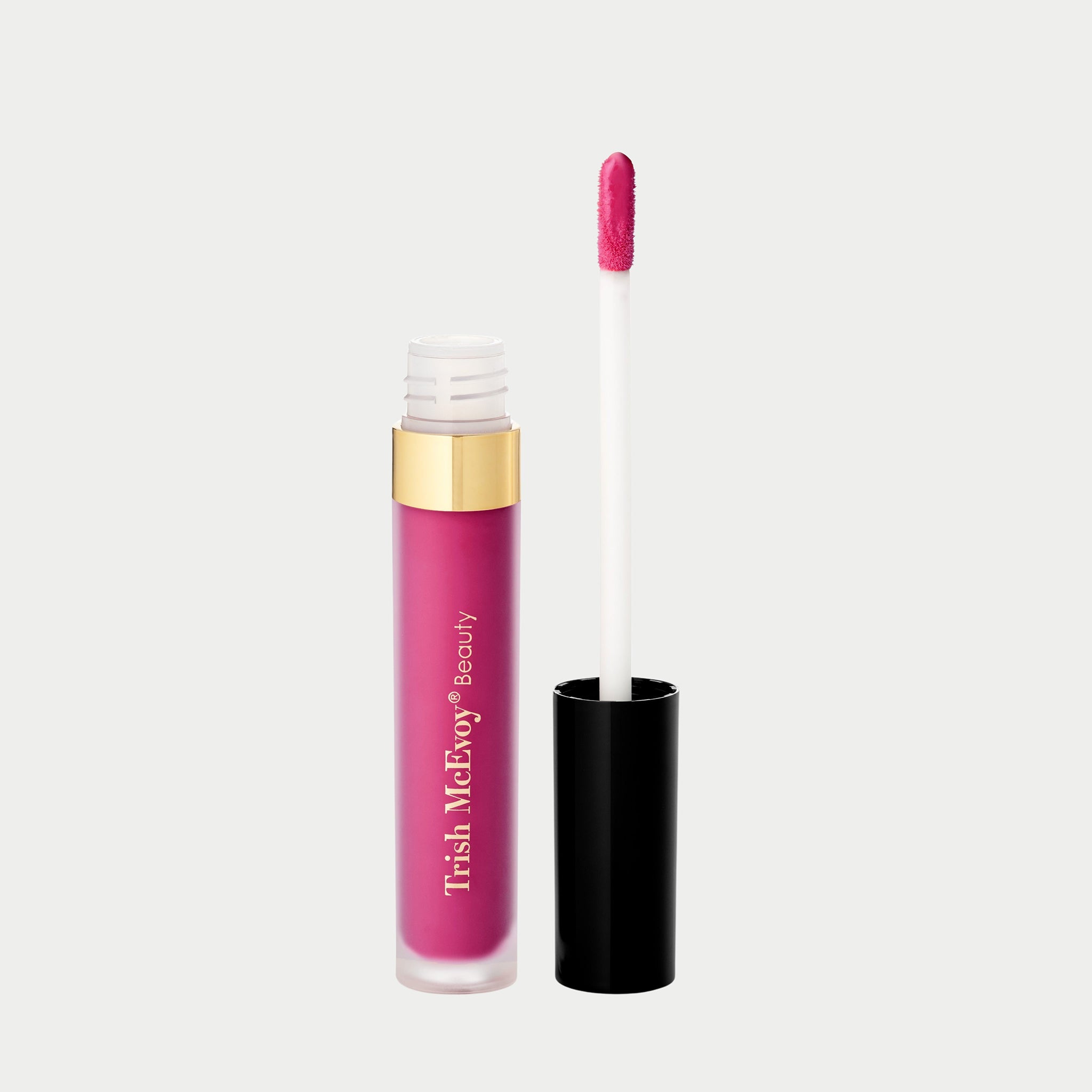 Trish McEvoy lip gloss with applicator on a light gray background