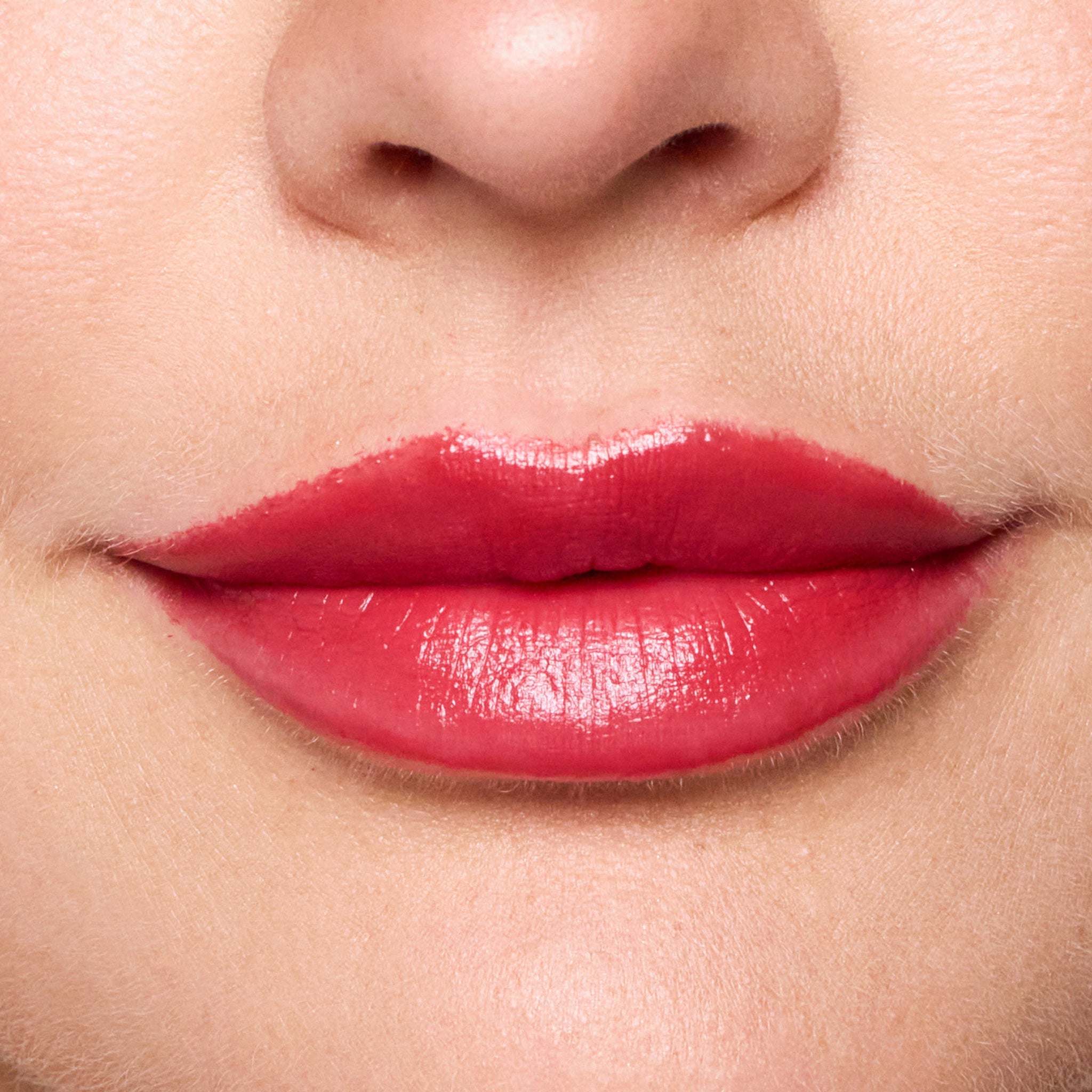 Close-up of a woman's lips with color rendezvous lipstick on a neutral background