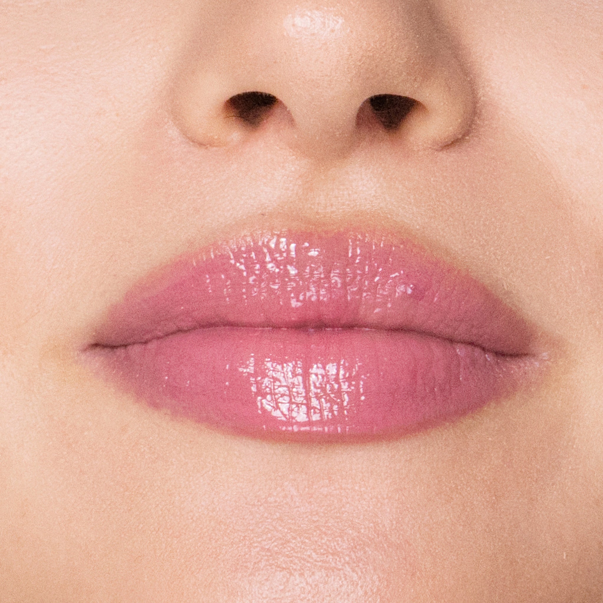 Close-up of a person's lips with timeless lip gloss