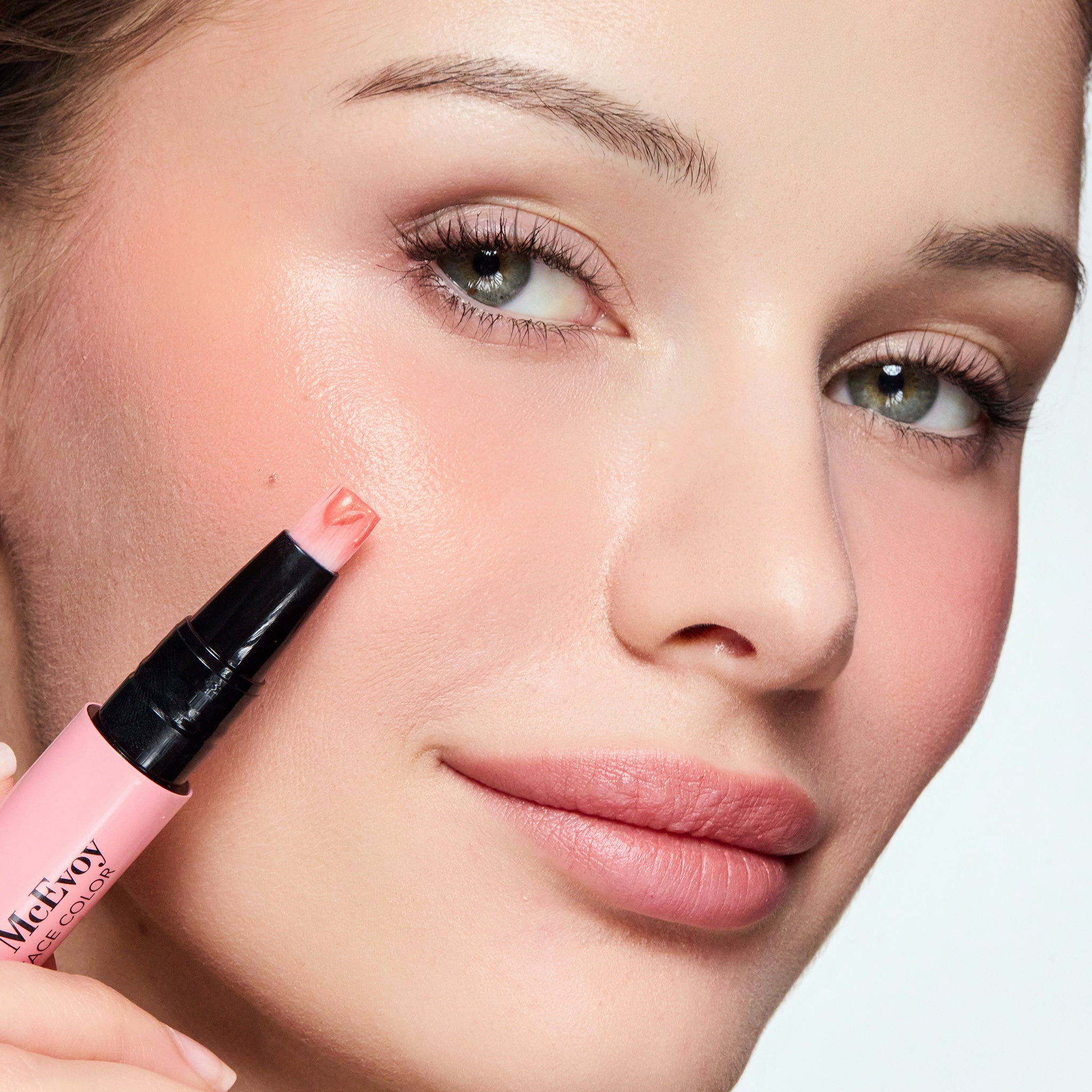 Woman applying color glow blush 