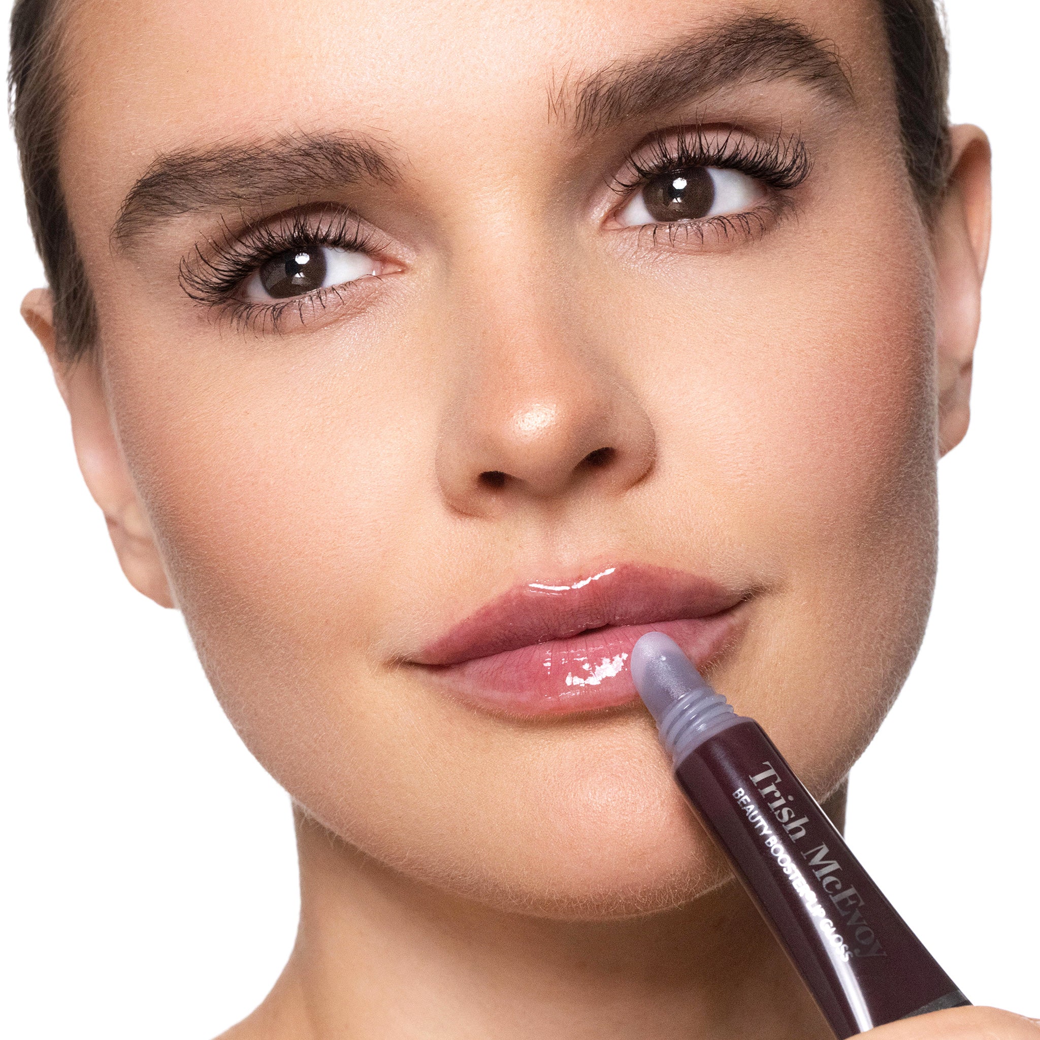 Woman applying Trish McEvoy Mulberry Lipgloss with a close-up of the product.