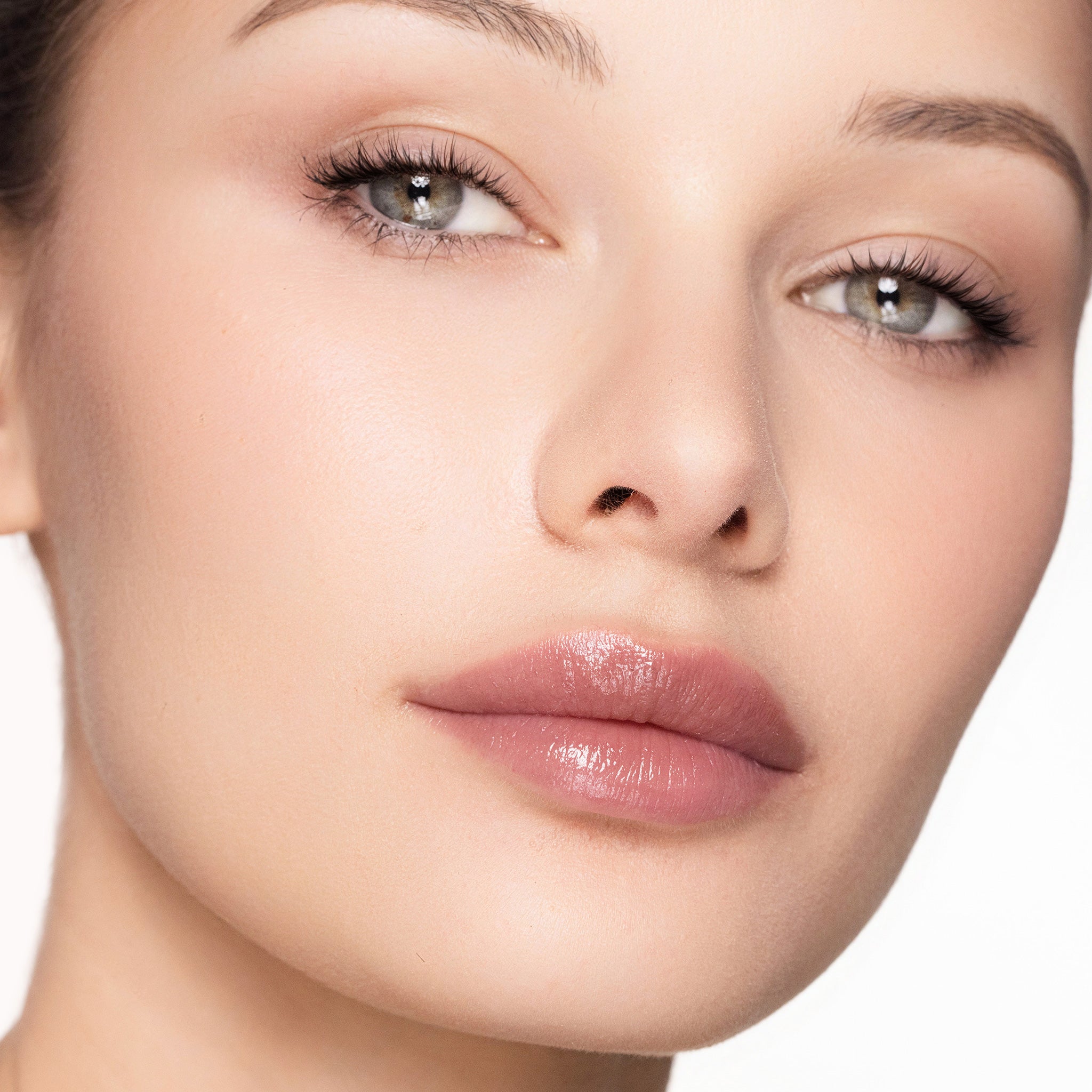 Close-up of a woman's face with a color mulberry lipgloss
