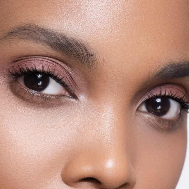 Close-up of a woman's face wearing color burnt sienna eye shadow