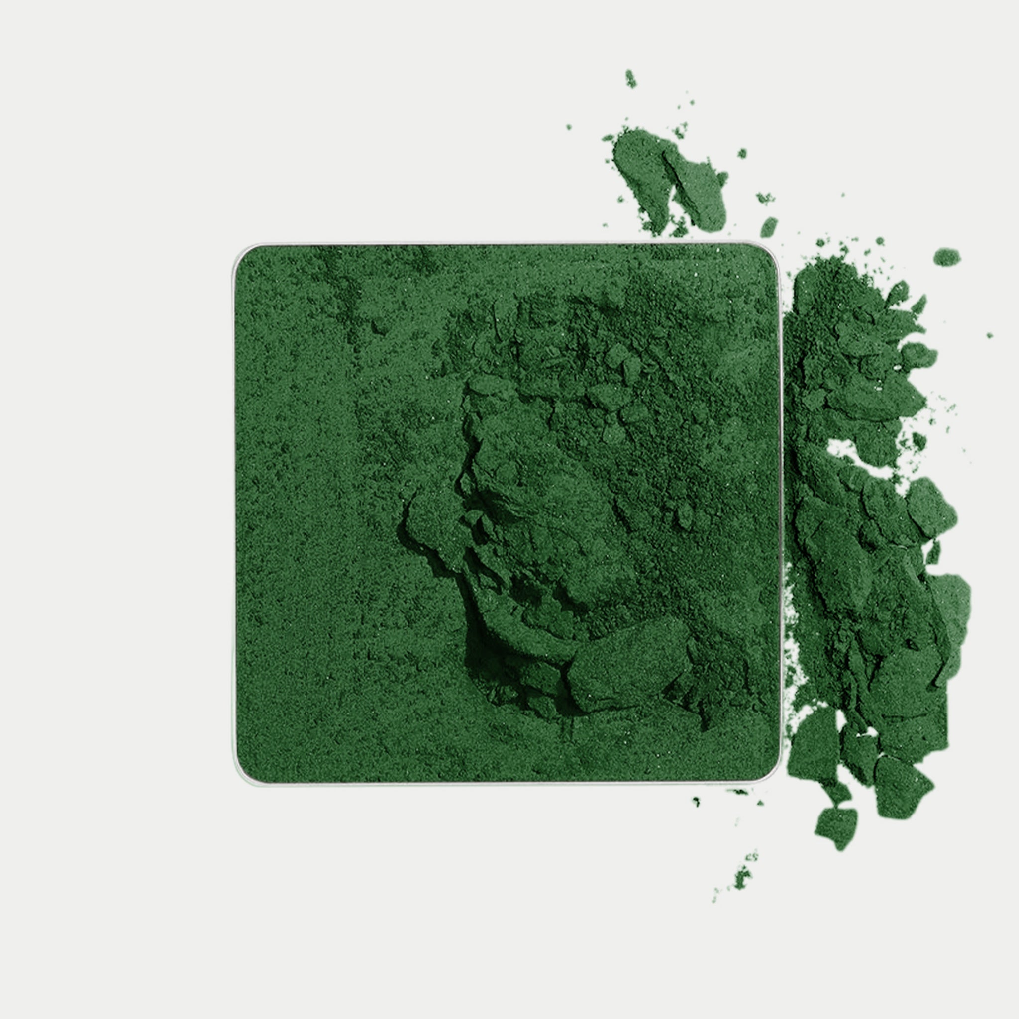 color lucky powder in a square container with spilled powder on a white background