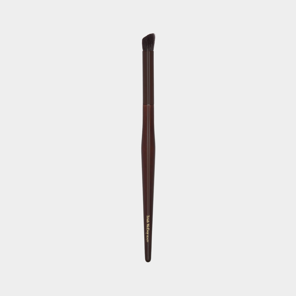 Makeup brush 23 define with brown handle and black bristle head on a white background