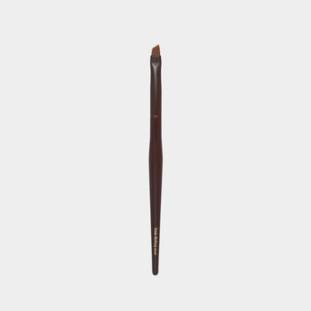 Makeup brush with brown handle and black bristle head on a light gray background