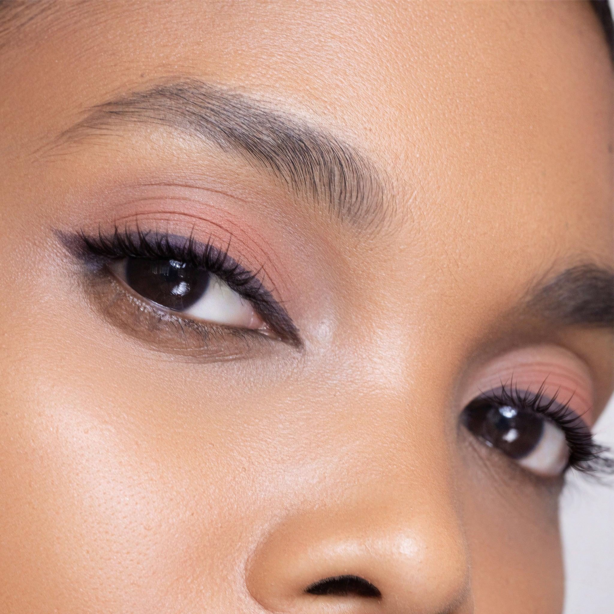 Close-up of a person's eye with colour deep aubergine makeup