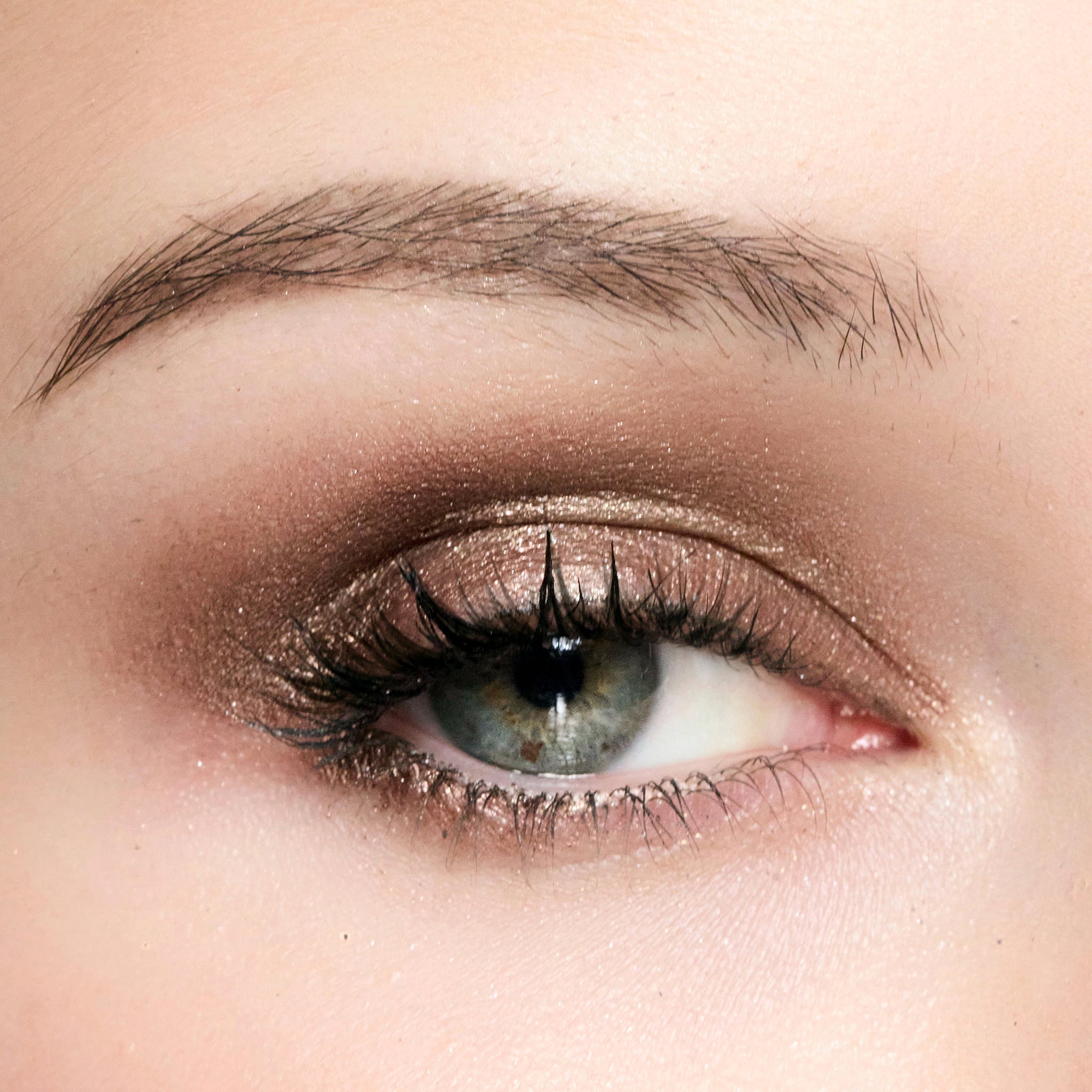 Close-up of a person's eye with color topaz eye makeup