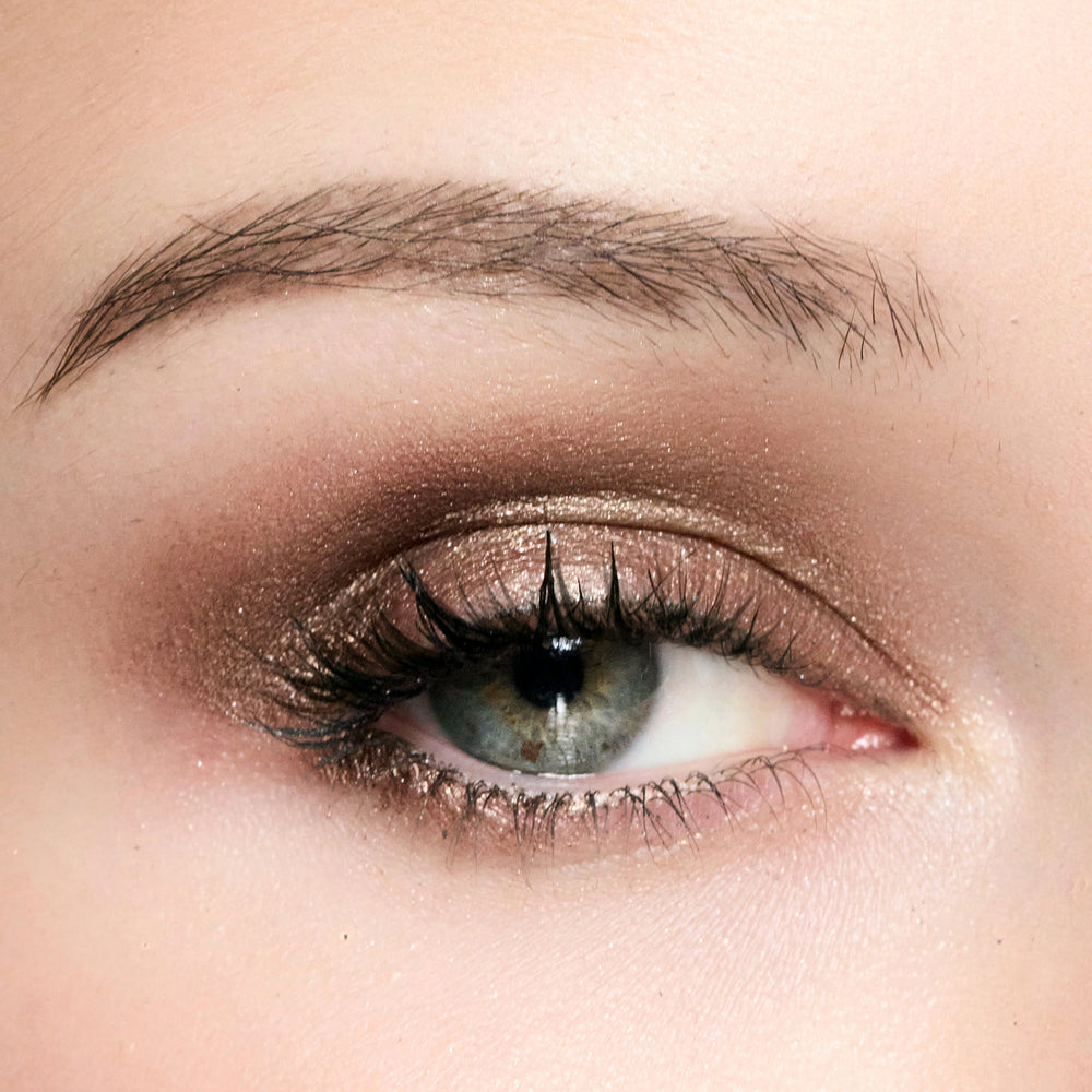 Close-up of a person's eye with color topaz eye makeup