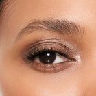 Close-up of a woman's eye with color topaz eyeshadow