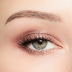 Close-up of a woman's eye with smoky quartz eye makeup