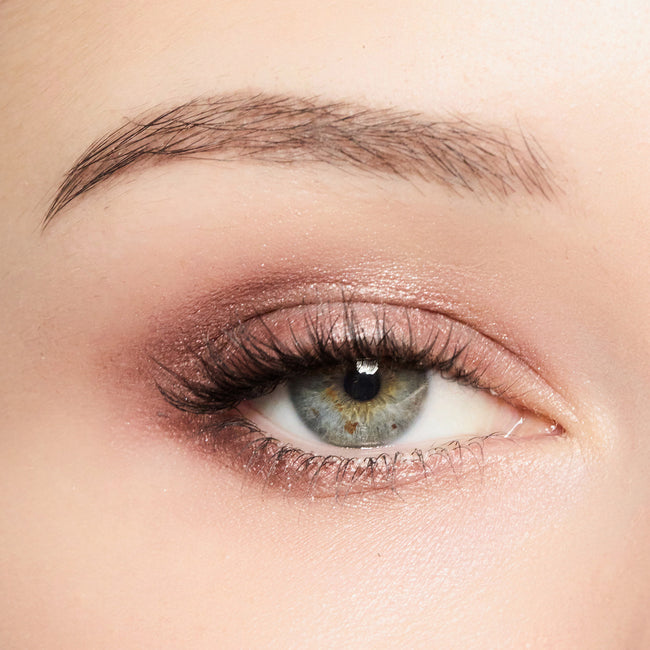 Close-up of a woman's eye with smoky quartz eye makeup