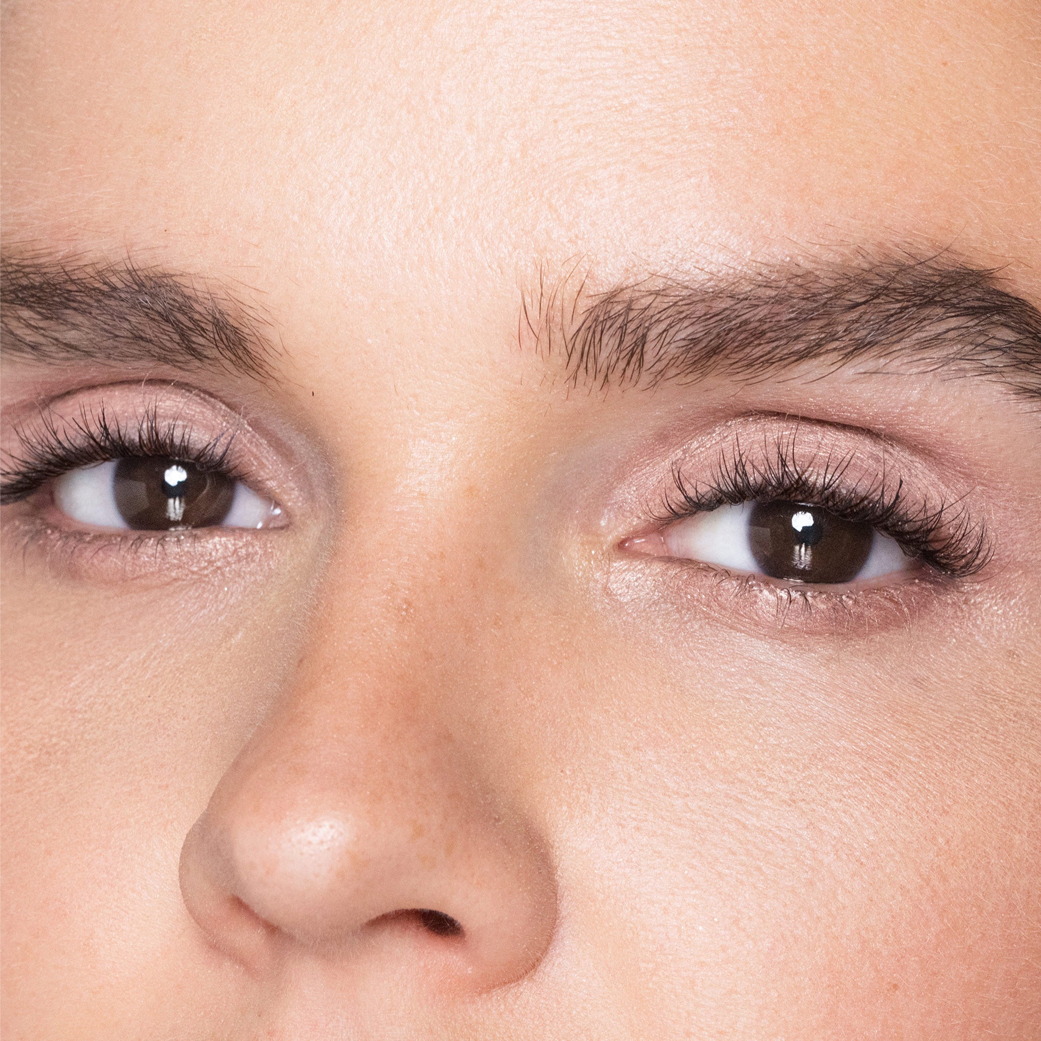 Close-up of a person's eyes with color rose quartz makeup