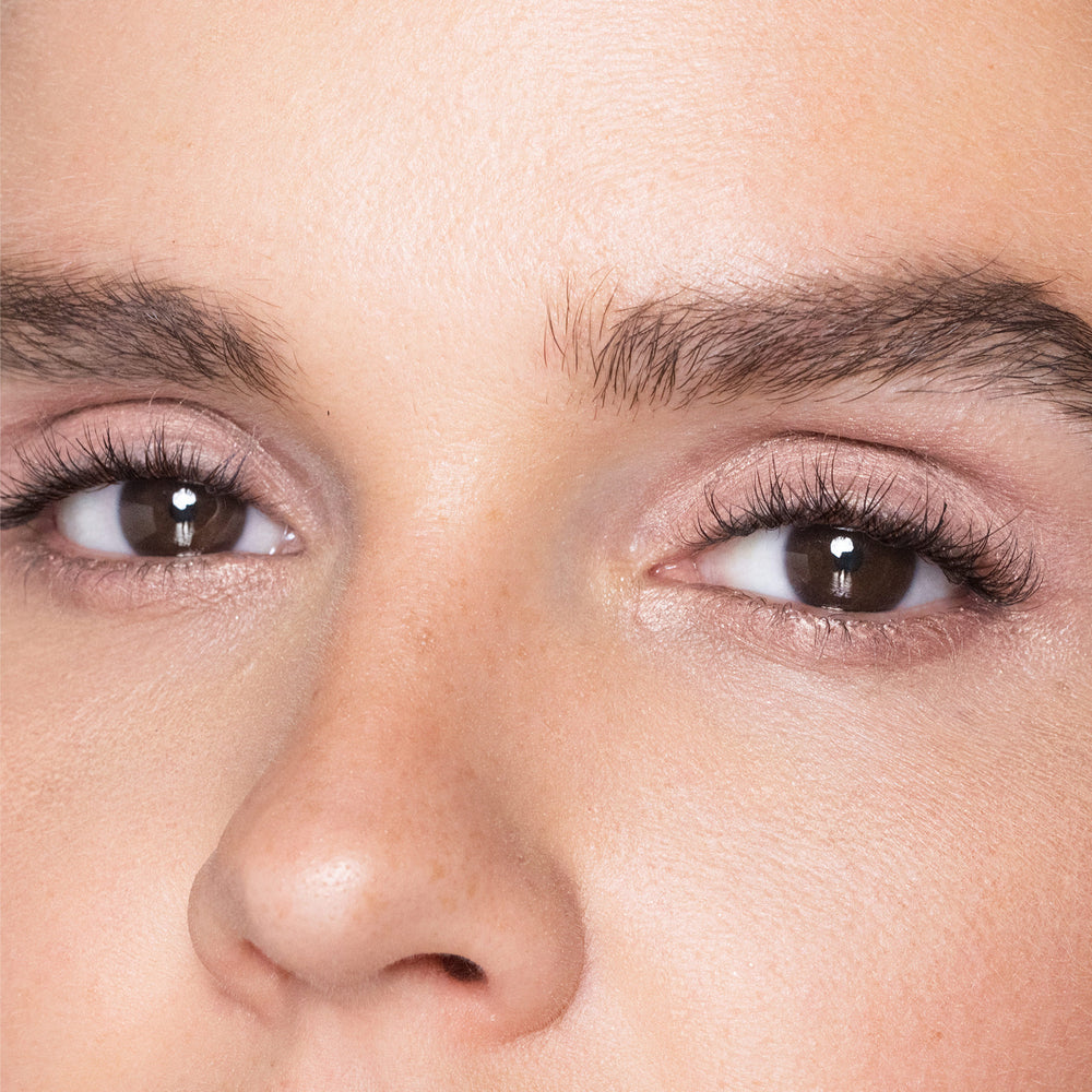 Close-up of a person's eyes with color rose quartz makeup