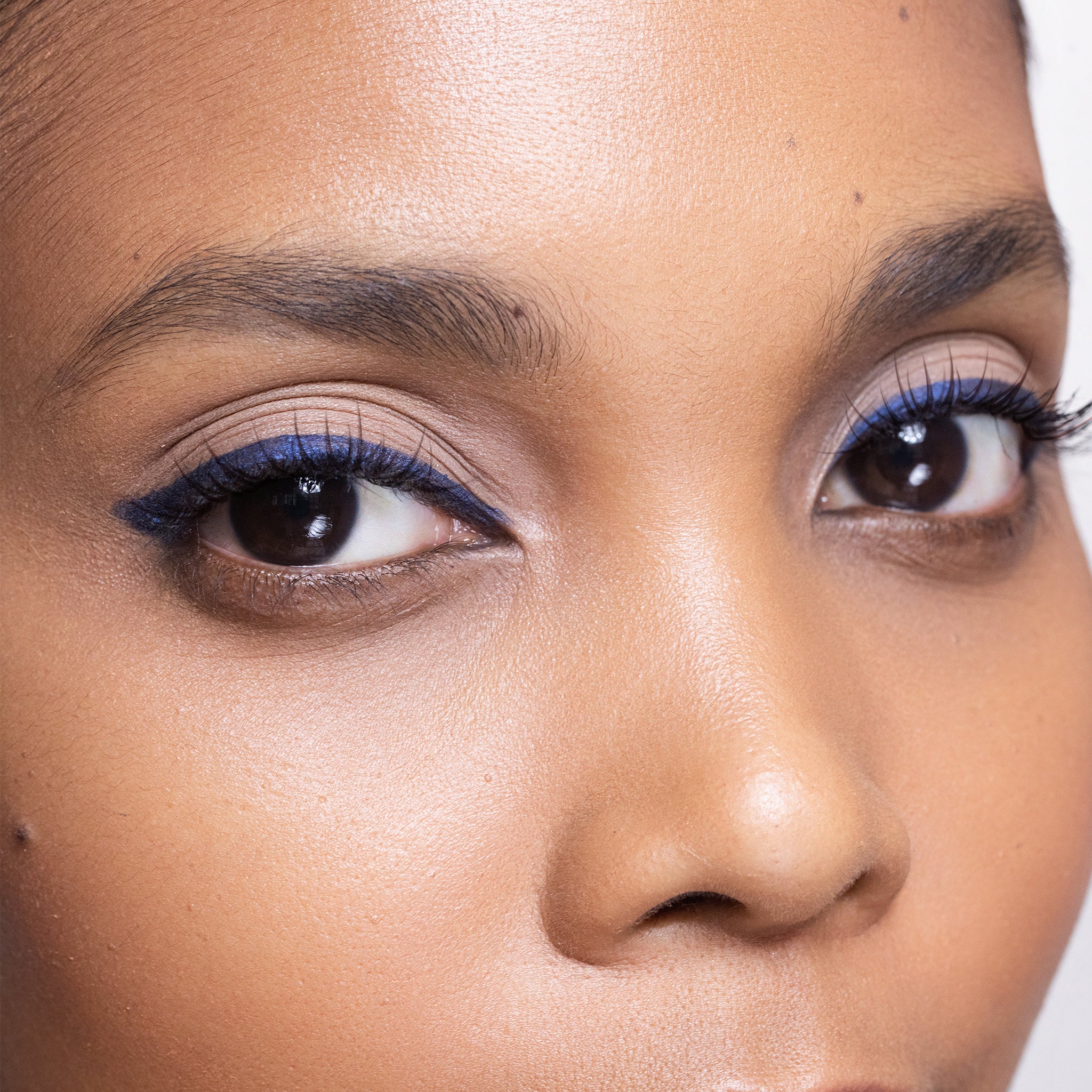 Close-up of a person's face with color Arabian Nights eyeliner